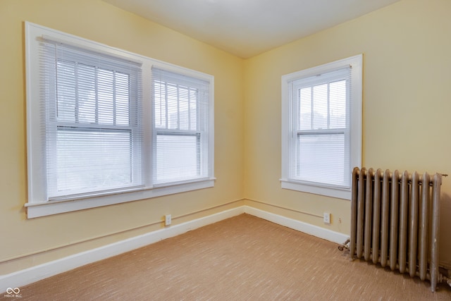 3619 Salem St, Indianapolis, IN 46208 - empty room featuring radiator, baseboards, and a healthy amount of sunlight