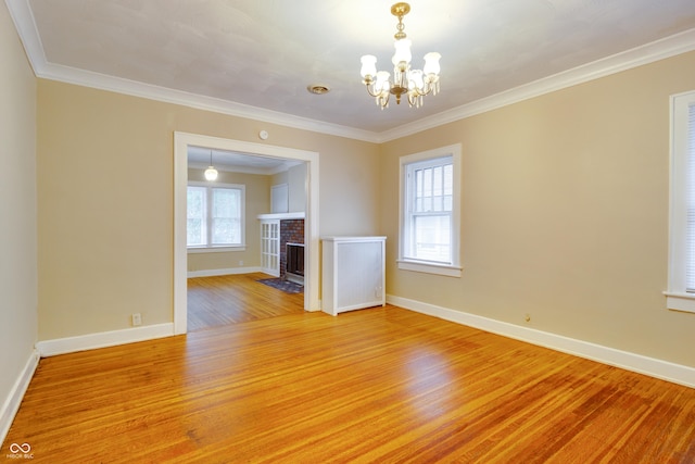 3619 Salem St, Indianapolis, IN 46208 - empty room featuring a notable chandelier, crown molding, baseboards, and light wood-type flooring