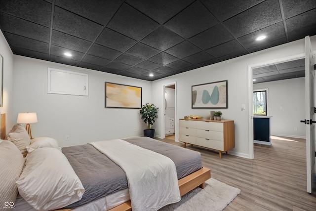 bedroom with light wood-style flooring, baseboards, and recessed lighting