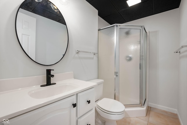 bathroom with toilet, tile patterned floors, a stall shower, and vanity