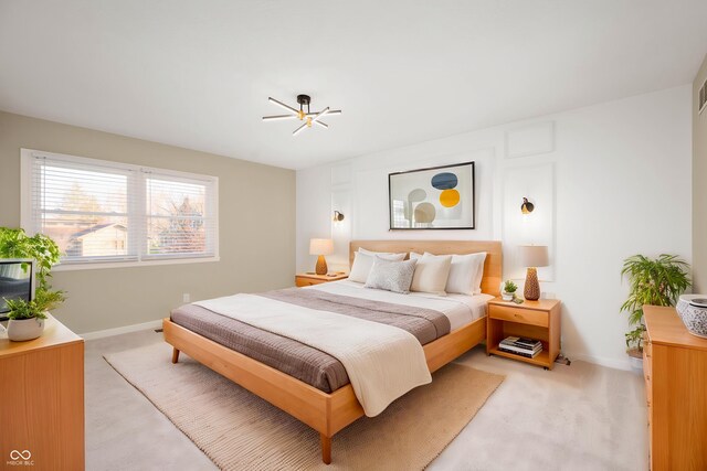 bedroom with light carpet and baseboards