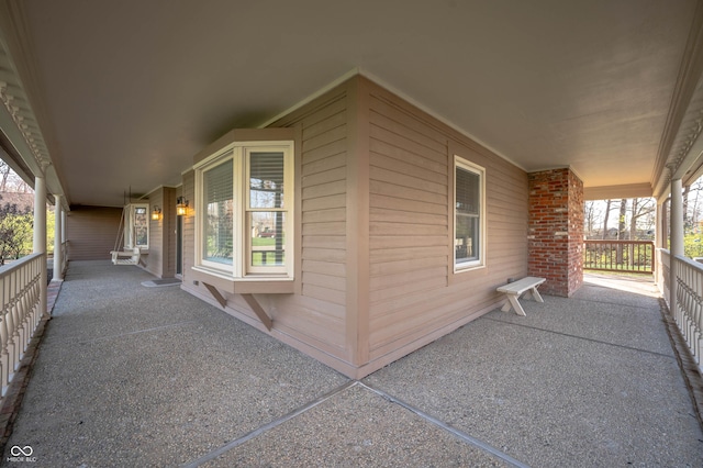 view of side of home featuring a porch