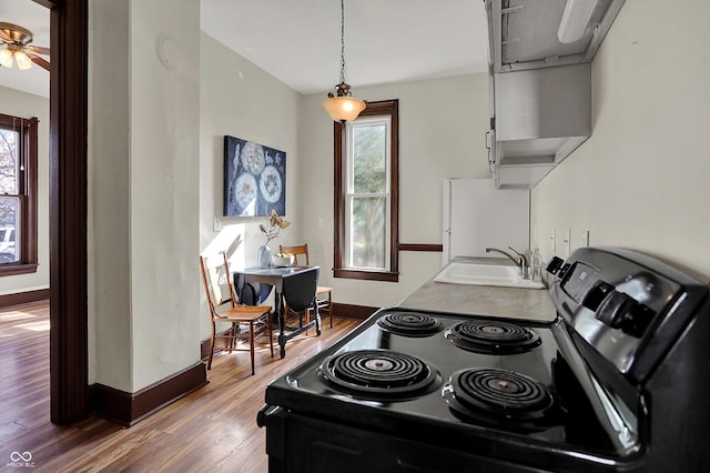 1157 Division St, Noblesville, IN 46060 - kitchen featuring electric range oven, wood finished floors, freestanding refrigerator, a ceiling fan, and hanging light fixtures