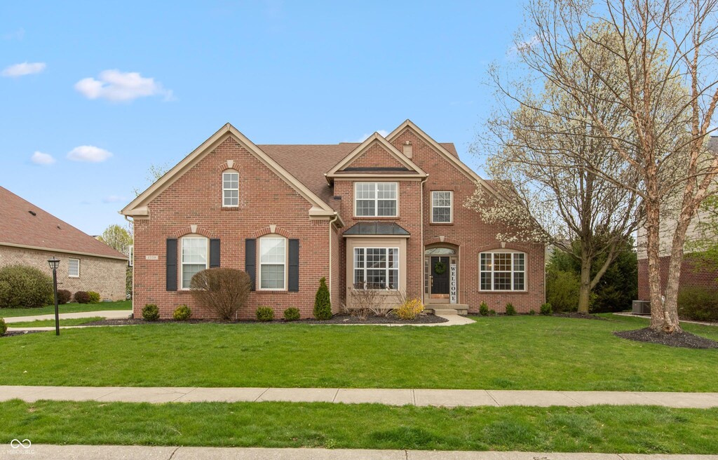 1559 Redsunset Dr, Brownsburg, IN 46112 - traditional-style house featuring a front yard and brick siding