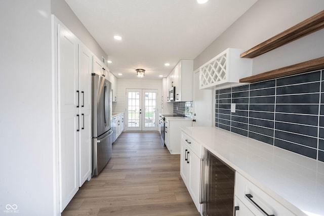 kitchen with french doors, open shelves, white cabinets, stainless steel appliances, and beverage cooler