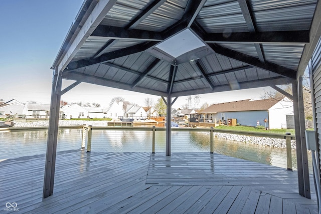 dock area featuring a gazebo, a residential view, and a deck with water view