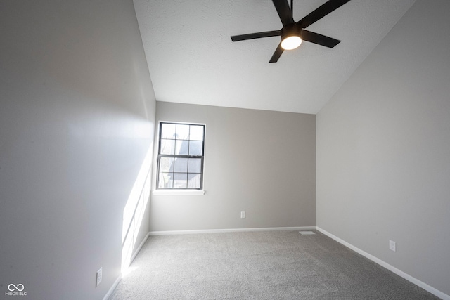 interior space featuring baseboards, ceiling fan, carpet, a textured ceiling, and lofted ceiling