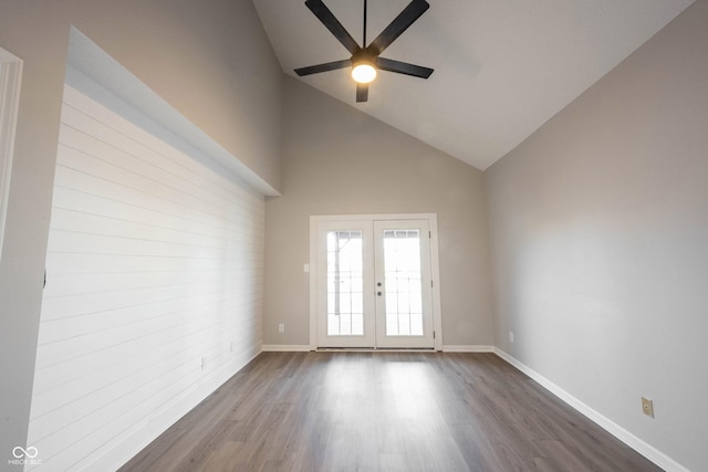 spare room featuring ceiling fan, high vaulted ceiling, dark wood-type flooring, french doors, and baseboards