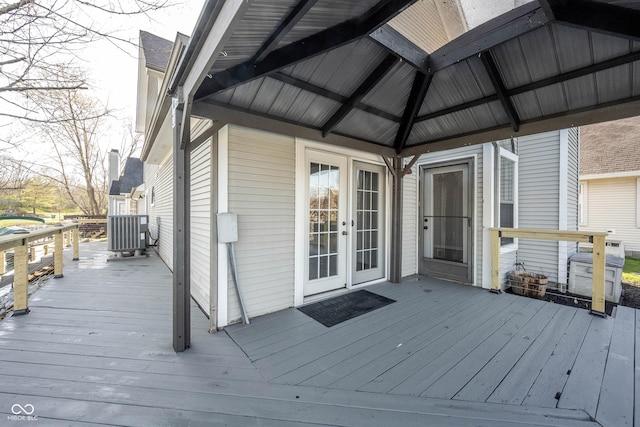 deck featuring central air condition unit, french doors, and a gazebo