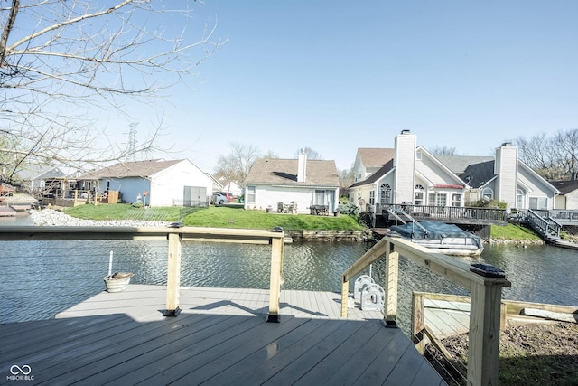 view of dock with a residential view and a deck with water view