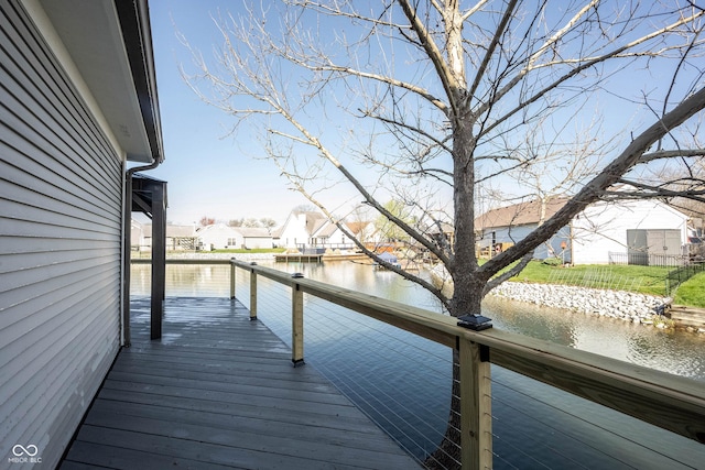 wooden deck with a water view and a residential view