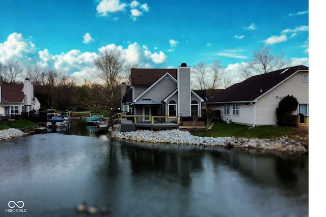 3260 Eddy Ct, Indianapolis, IN 46214 - back of house featuring a chimney, a deck with water view, and a lawn
