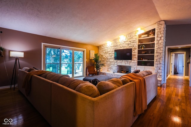 living area featuring vaulted ceiling, built in shelves, a textured ceiling, baseboards, and hardwood / wood-style floors