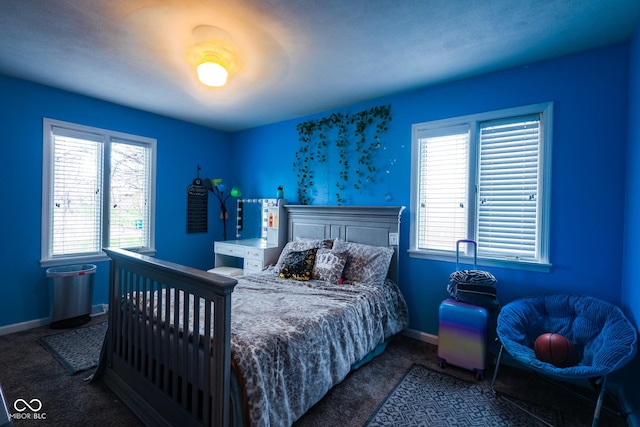 bedroom featuring carpet floors and baseboards