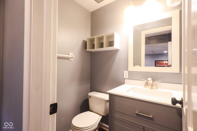 bathroom featuring toilet and vanity