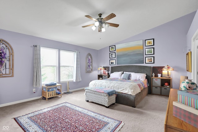 bedroom with carpet floors, vaulted ceiling, baseboards, and ceiling fan