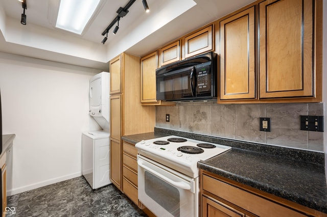 2804 Paso Del Norte Dr, Indianapolis, IN 46227 - kitchen featuring black microwave, white electric range oven, stacked washing machine and dryer, backsplash, and rail lighting
