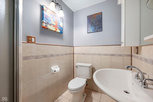 2804 Paso Del Norte Dr, Indianapolis, IN 46227 - half bath featuring a sink, tile walls, toilet, tile patterned floors, and a wainscoted wall