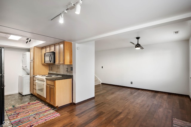 2804 Paso Del Norte Dr, Indianapolis, IN 46227 - kitchen with black microwave, white range with electric stovetop, stacked washer / drying machine, and dark wood-type flooring