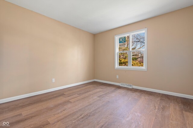 745 W Banta Rd, Indianapolis, IN 46217 - empty room with visible vents, baseboards, and wood finished floors