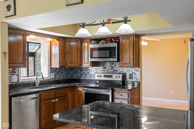 745 W Banta Rd, Indianapolis, IN 46217 - kitchen featuring tasteful backsplash, brown cabinets, a sink, and stainless steel appliances