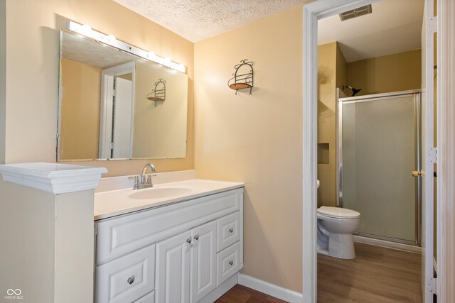 745 W Banta Rd, Indianapolis, IN 46217 - bathroom featuring visible vents, a textured ceiling, vanity, wood finished floors, and a stall shower