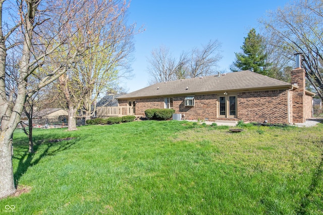 745 W Banta Rd, Indianapolis, IN 46217 - back of house featuring brick siding, roof with shingles, a lawn, and a chimney