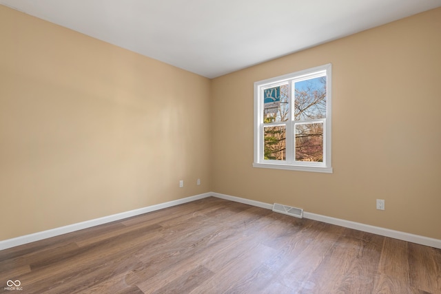 745 W Banta Rd, Indianapolis, IN 46217 - spare room with visible vents, baseboards, and wood finished floors