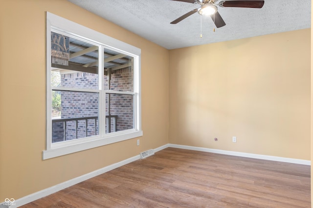 745 W Banta Rd, Indianapolis, IN 46217 - unfurnished room with visible vents, baseboards, a textured ceiling, and wood finished floors