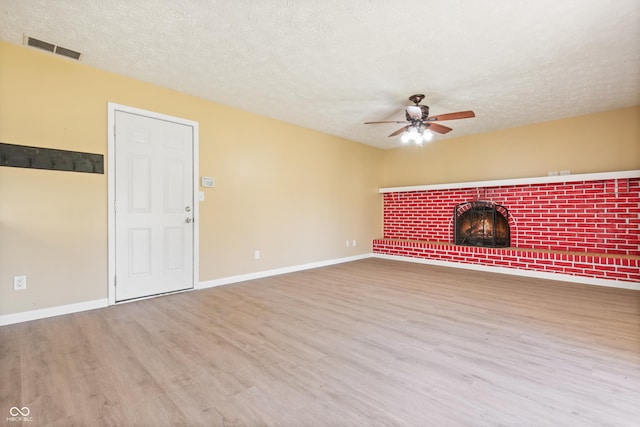 745 W Banta Rd, Indianapolis, IN 46217 - unfurnished living room featuring baseboards, a fireplace, visible vents, ceiling fan, and wood finished floors