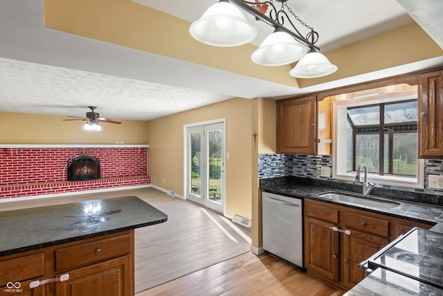 745 W Banta Rd, Indianapolis, IN 46217 - kitchen with light wood-style floors, tasteful backsplash, dishwasher, a sink, and open floor plan