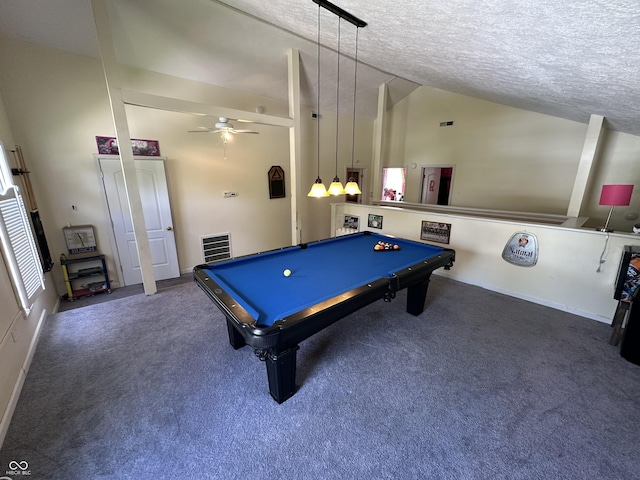 recreation room with a ceiling fan, vaulted ceiling, carpet flooring, and a textured ceiling