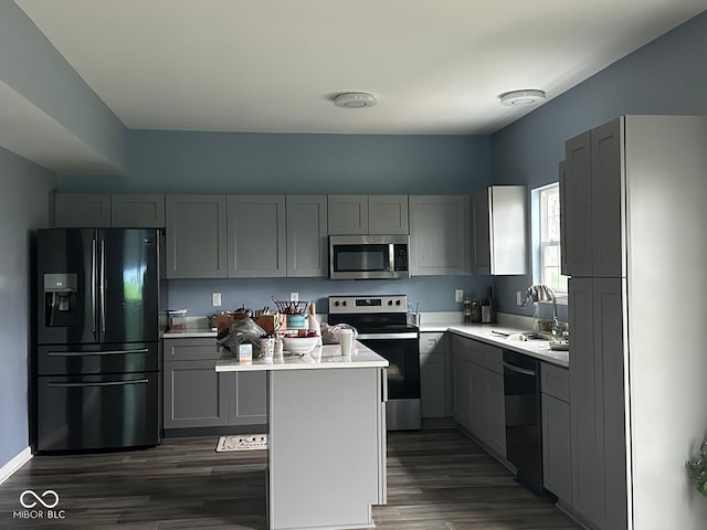 1071 Hazelwood Dr, Greenwood, IN 46143 - kitchen with dark wood-style floors, light countertops, black appliances, gray cabinetry, and a sink