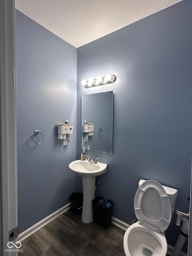 1071 Hazelwood Dr, Greenwood, IN 46143 - half bathroom with baseboards, toilet, and wood finished floors