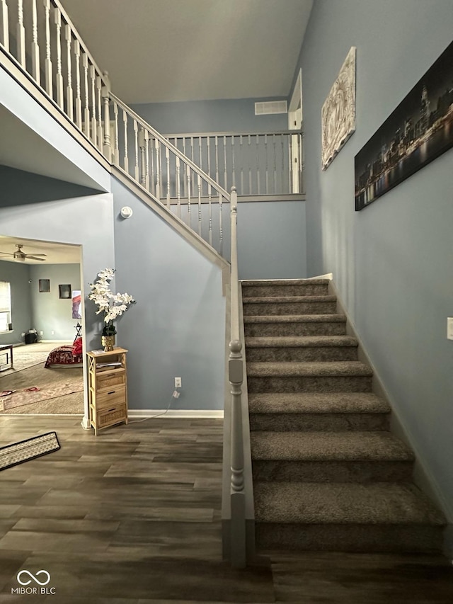 1071 Hazelwood Dr, Greenwood, IN 46143 - stairway with a towering ceiling, baseboards, a ceiling fan, and wood finished floors