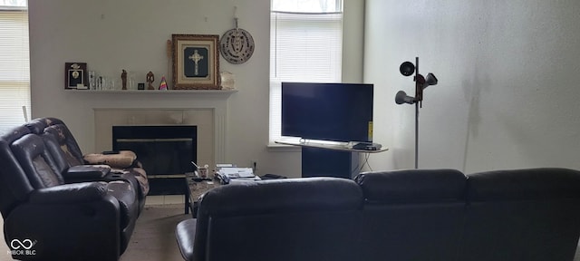 living room featuring a tiled fireplace