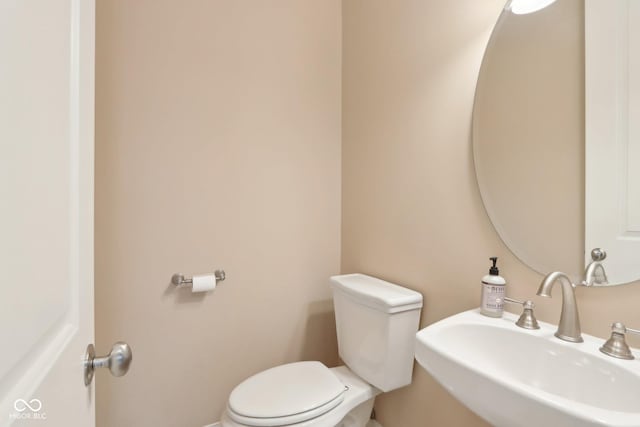bathroom with toilet and a sink