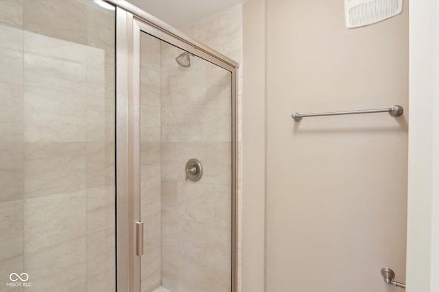 bathroom with visible vents and a stall shower