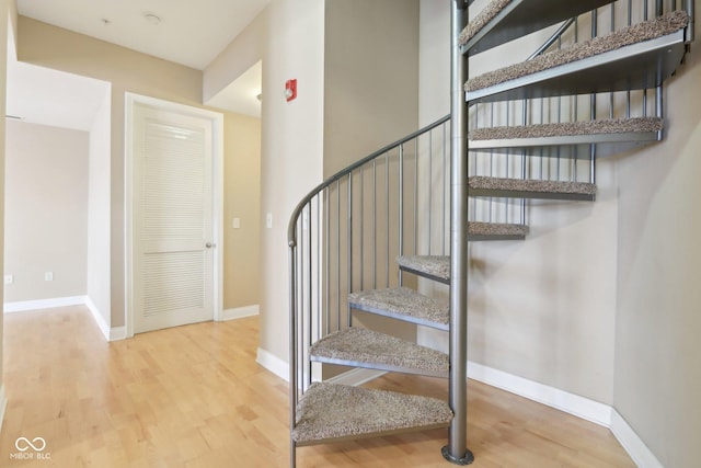 stairs featuring baseboards and wood finished floors