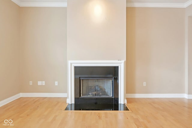 interior details with crown molding, baseboards, and wood finished floors