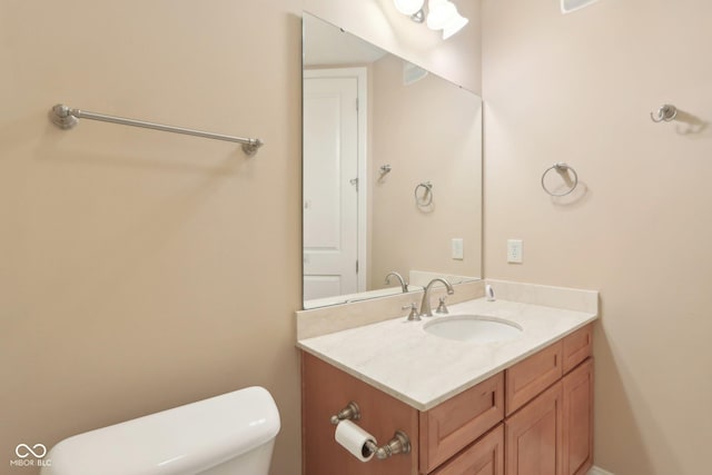 half bathroom with toilet and vanity
