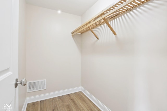 walk in closet with light wood-style flooring and visible vents