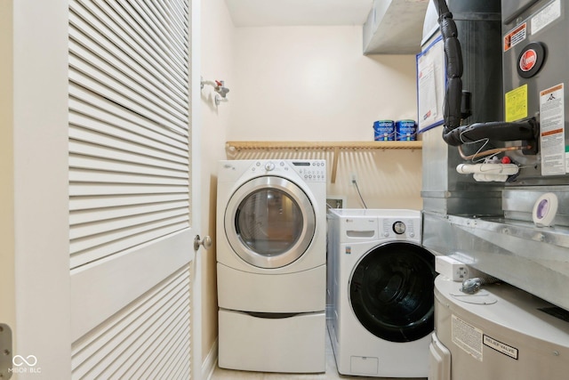 laundry area with heating unit, laundry area, and washer and dryer
