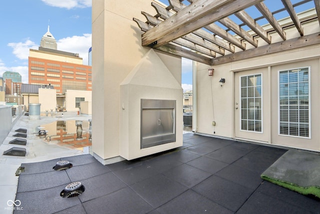 view of patio / terrace with a pergola, cooling unit, and a view of city