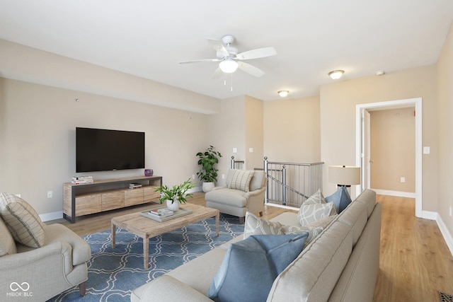 355 E Ohio St Unit 309, Indianapolis, IN 46204 - living area featuring light wood-style floors, a ceiling fan, and baseboards
