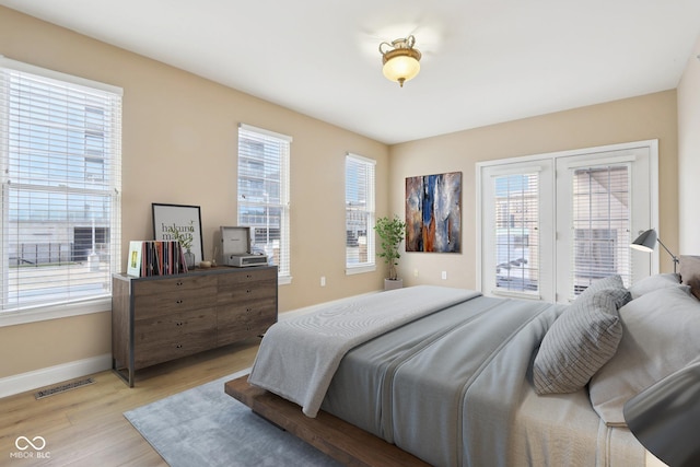 355 E Ohio St Unit 309, Indianapolis, IN 46204 - bedroom with access to exterior, light wood finished floors, and baseboards