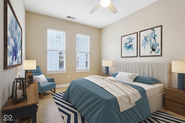 355 E Ohio St Unit 309, Indianapolis, IN 46204 - bedroom with baseboards, ceiling fan, and light wood-style flooring