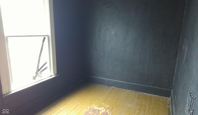empty room with hardwood / wood-style flooring