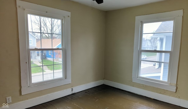 spare room with baseboards and ceiling fan