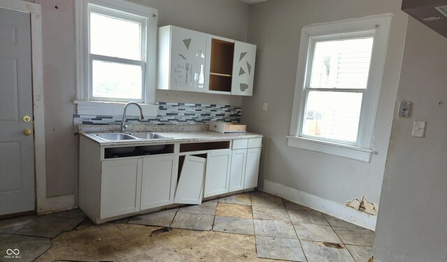 kitchen with a sink, tasteful backsplash, and plenty of natural light